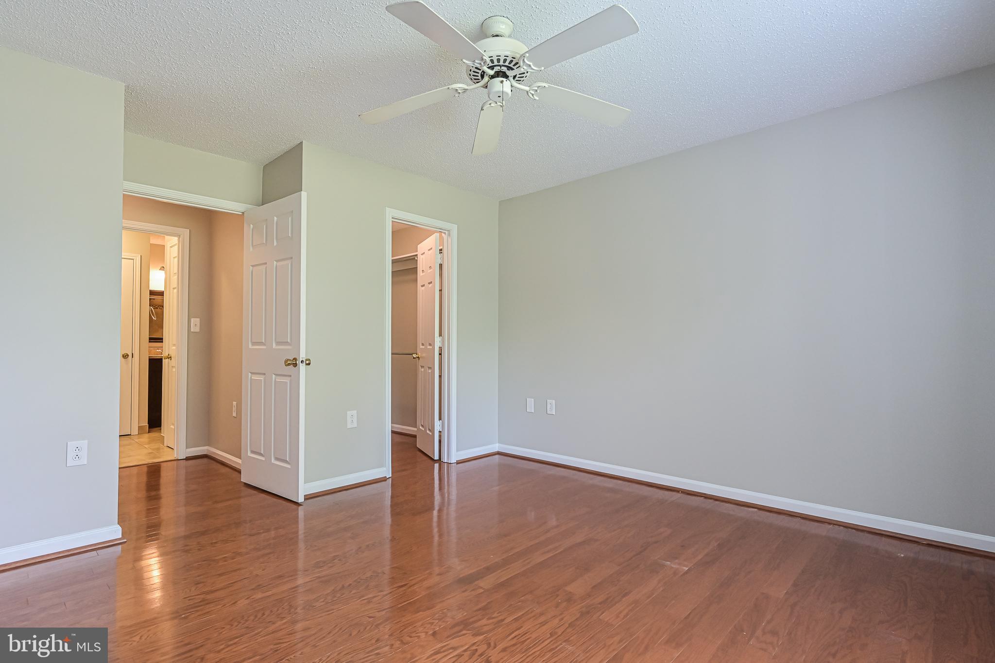 20952 Timber Ridge Terrace, Unit 103 Ashburn, VA 20147 - Photo 15 of 24 Cooling ceiling fan in bedroom