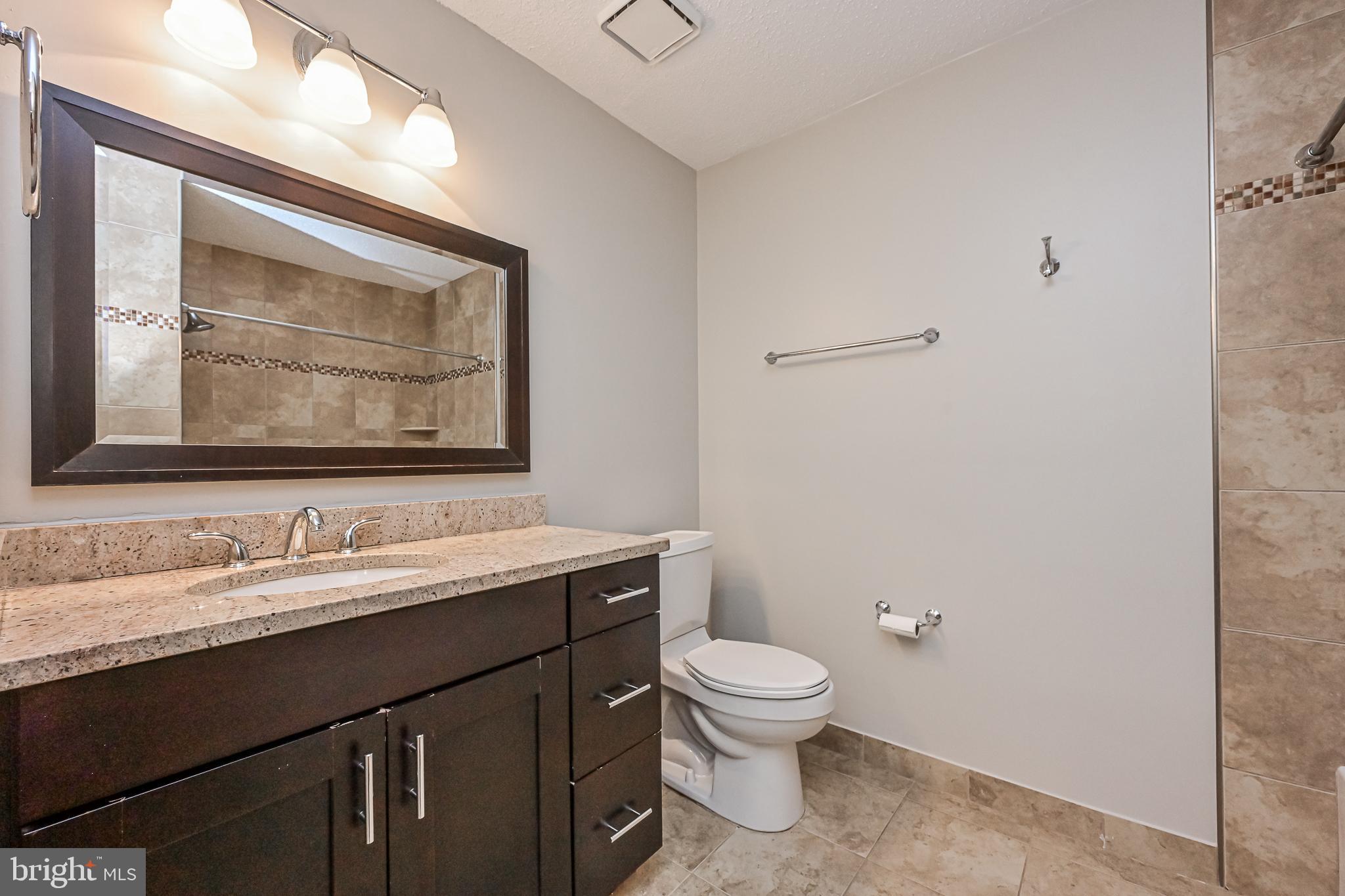 20952 Timber Ridge Terrace, Unit 103 Ashburn, VA 20147 - Photo 18 of 24 Updated bathroom with ceramic tile