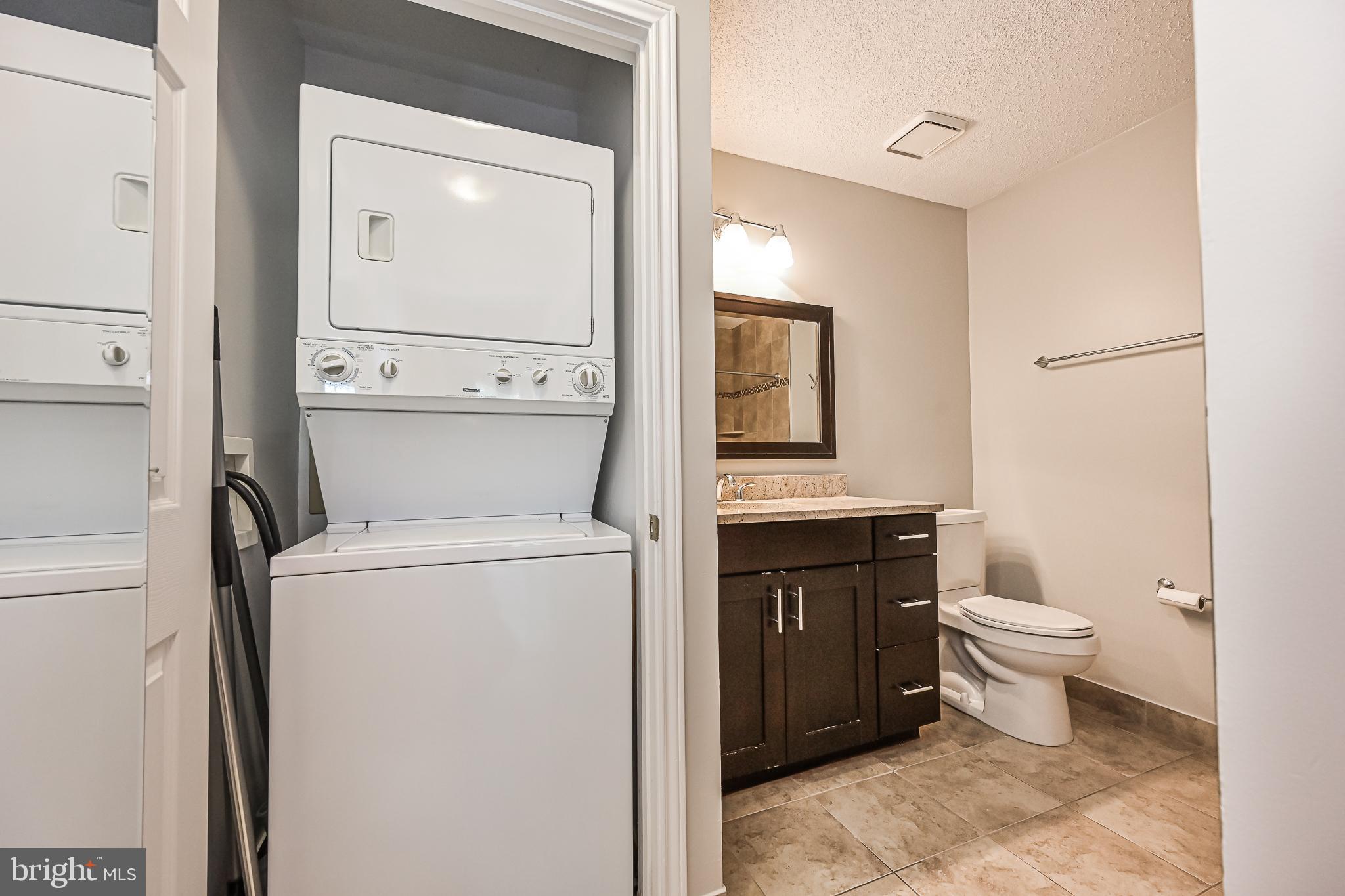 20952 Timber Ridge Terrace, Unit 103 Ashburn, VA 20147 - Photo 21 of 24 Convenient stackable washer and dryer in hallway