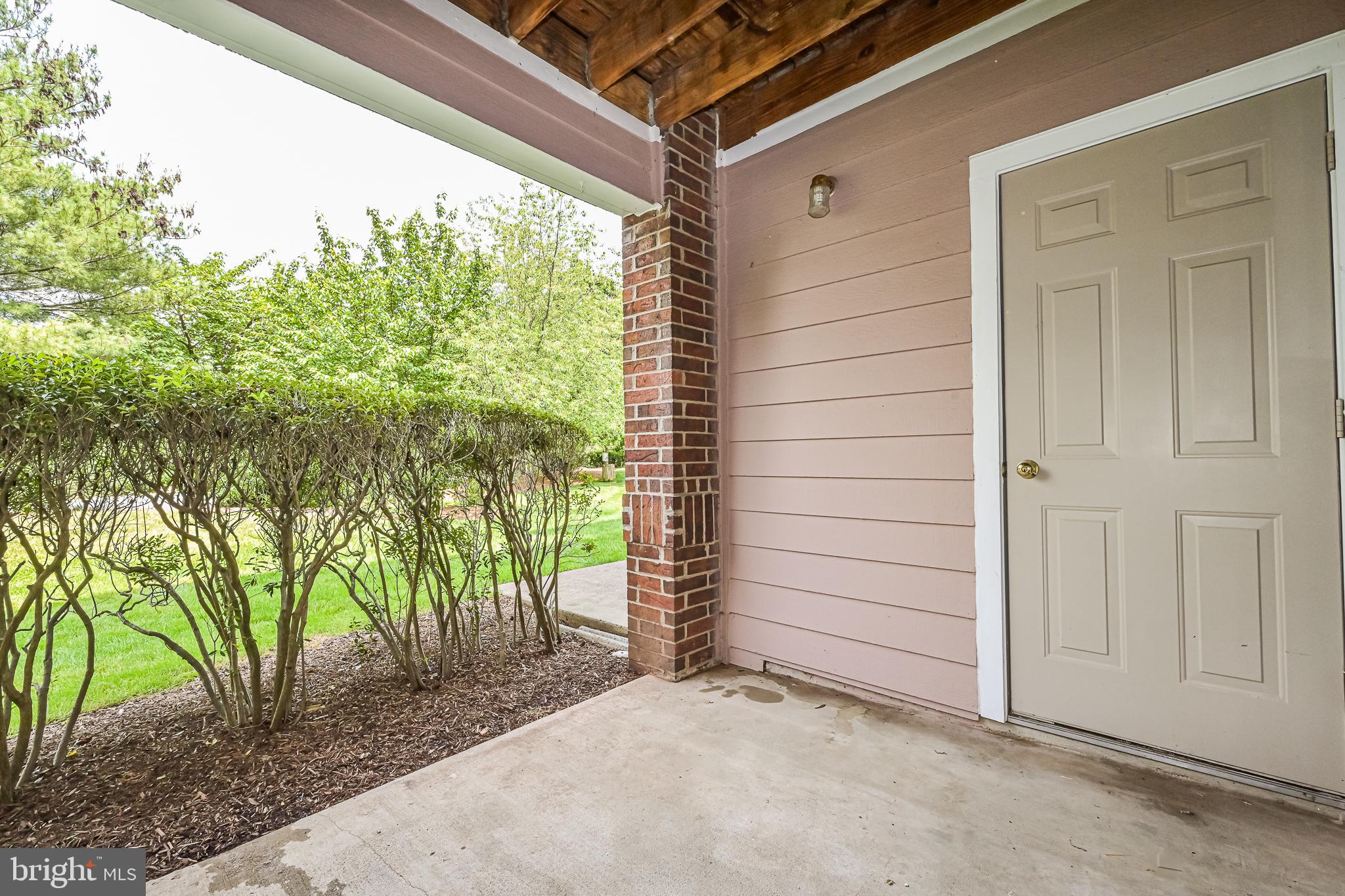 20952 Timber Ridge Terrace, Unit 103 Ashburn, VA 20147 - Photo 23 of 24 Outdoor patio with storage room