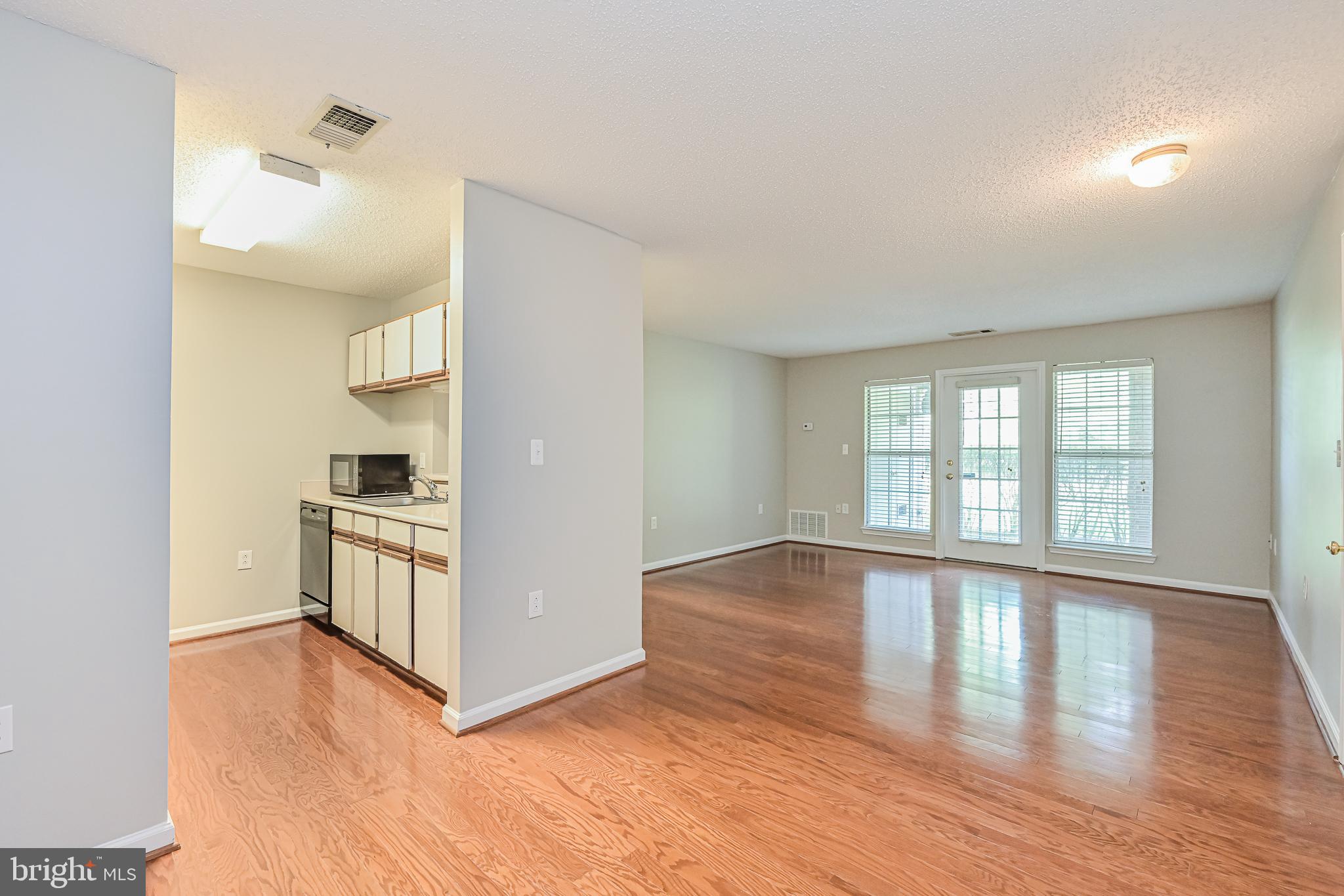 20952 Timber Ridge Terrace, Unit 103 Ashburn, VA 20147 - Photo 10 of 24 view from dining room to living room and kitchen