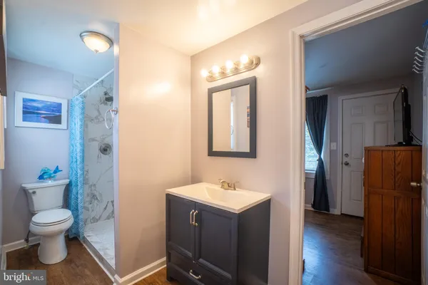 a bathroom with a toilet a sink and mirror