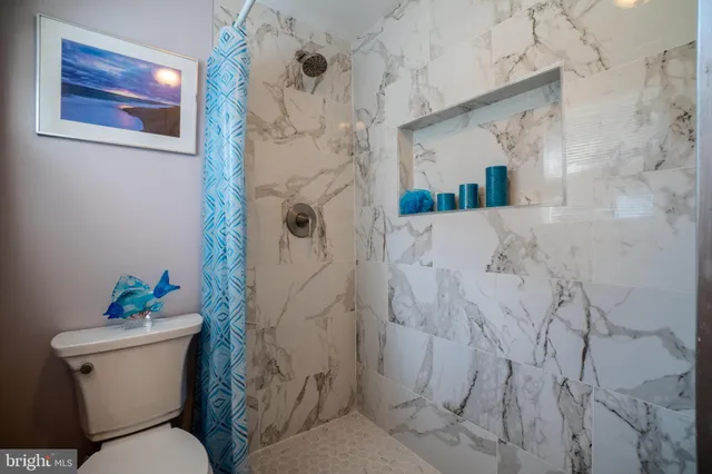 a white toilet sitting next to a bathroom sink