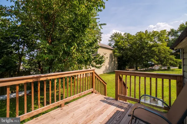 a view of balcony with wooden floor and fence
