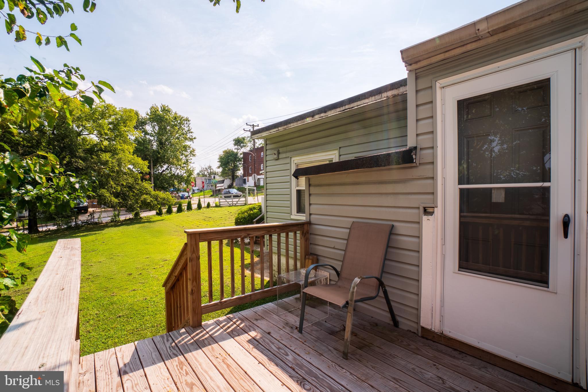 4415 Fairhaven Avenue Curtis Bay, MD 21226 - Photo 24 of 27 a balcony with wooden floor table and chairs