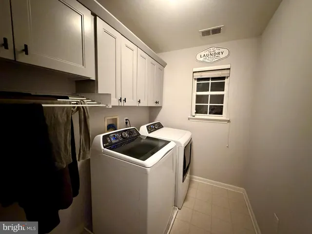 a kitchen with a refrigerator sink and cabinets