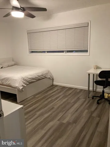 a bedroom with a bed and a table in it