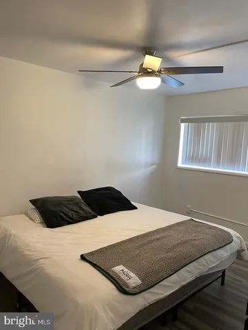 a bedroom with a bed and window