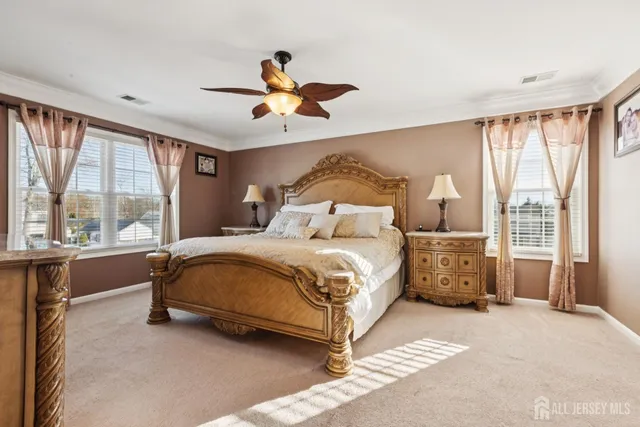 a bedroom with a large bed and a large window