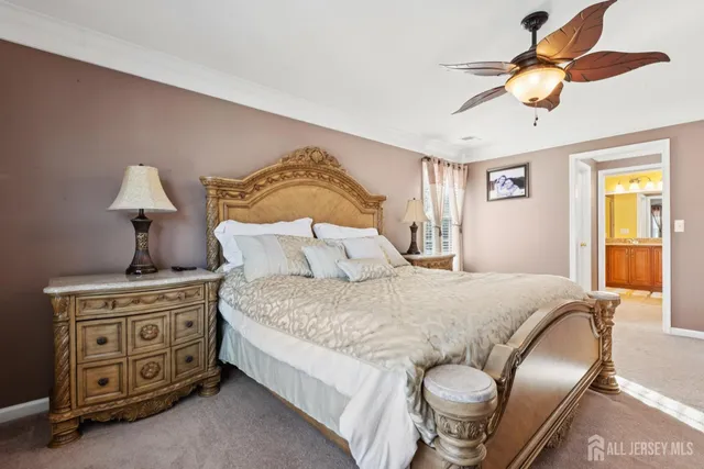 a spacious bedroom with a bed and a chandelier