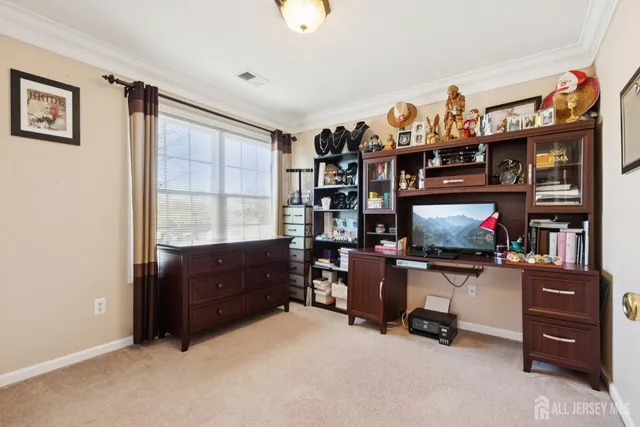 a bedroom with a workspace and a window