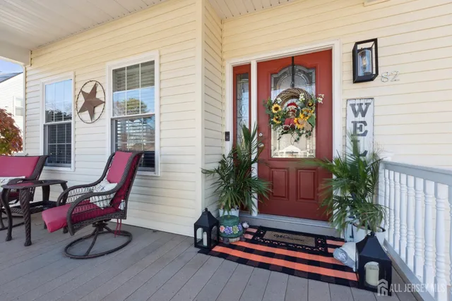 a living room filled with furniture hardwood floor and a potted plant