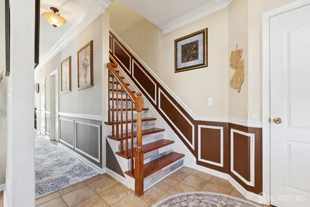 a view of staircase with lots of frames on wall and a window