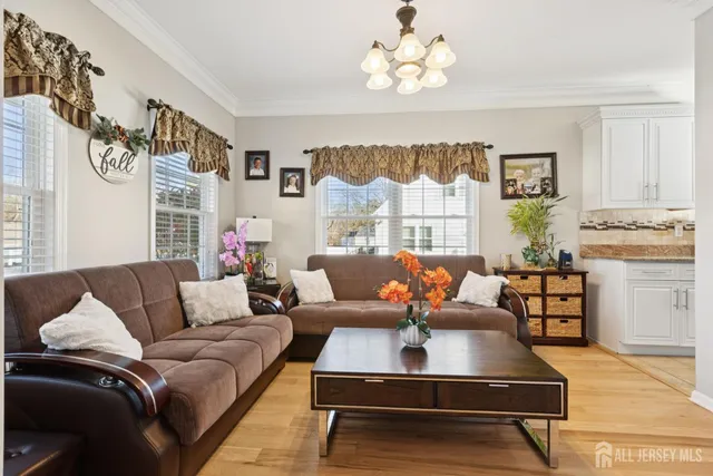 a living room with fireplace furniture and a large window
