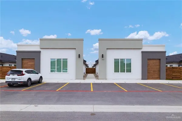 a front view of a house with a parking space