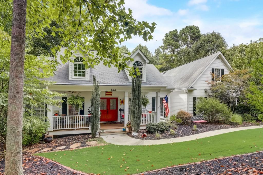 a view of a house with brick walls and a yard with plants