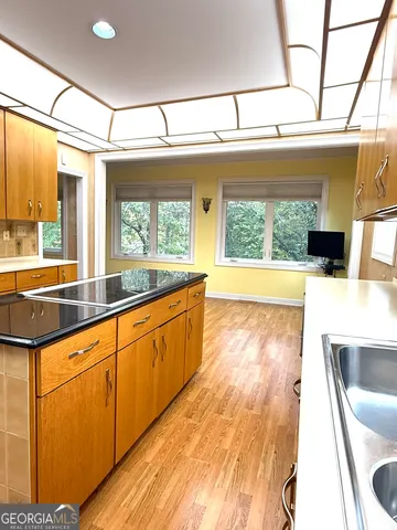 a large white kitchen with a large window
