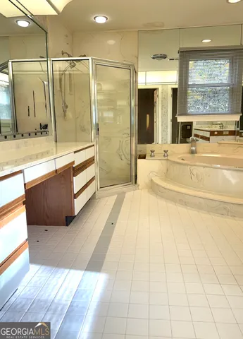 a spacious bathroom with a tub shower and sink
