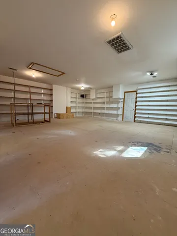 a view of an empty room with a fireplace