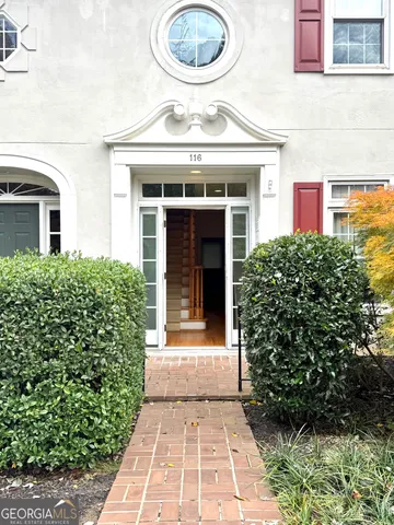 front view of a brick house with a large window