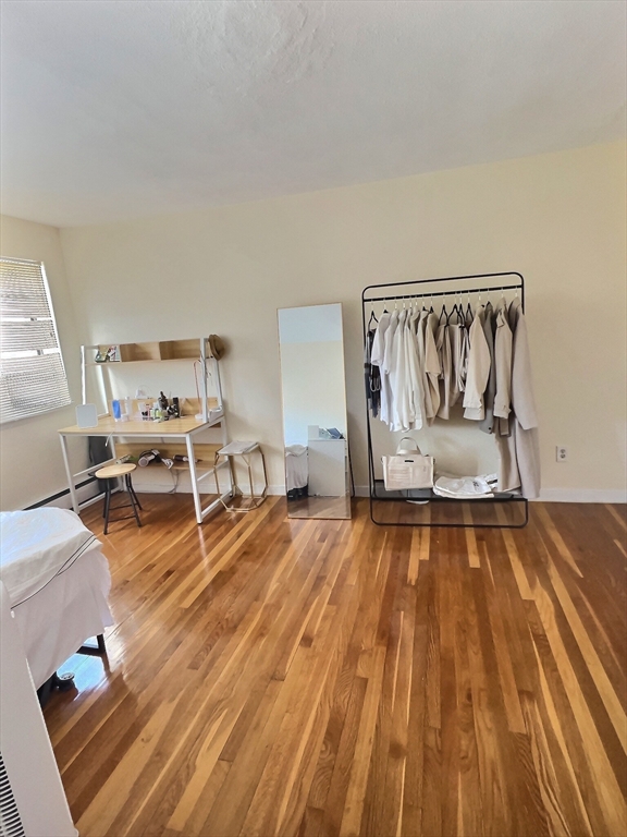 1027 Commonwealth Avenue, Unit 32 Boston, MA 02215 - Photo 6 of 8 a room with wooden floor and pool table