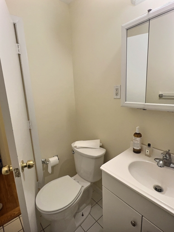 1027 Commonwealth Avenue, Unit 32 Boston, MA 02215 - Photo 7 of 8 a bathroom with a sink a toilet and a mirror