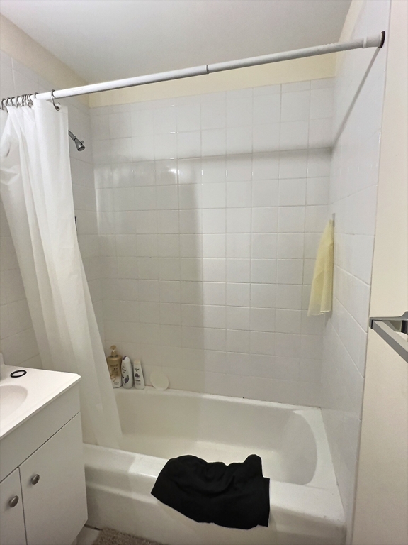 1027 Commonwealth Avenue, Unit 32 Boston, MA 02215 - Photo 8 of 8 a bathroom with a shower curtain and a sink