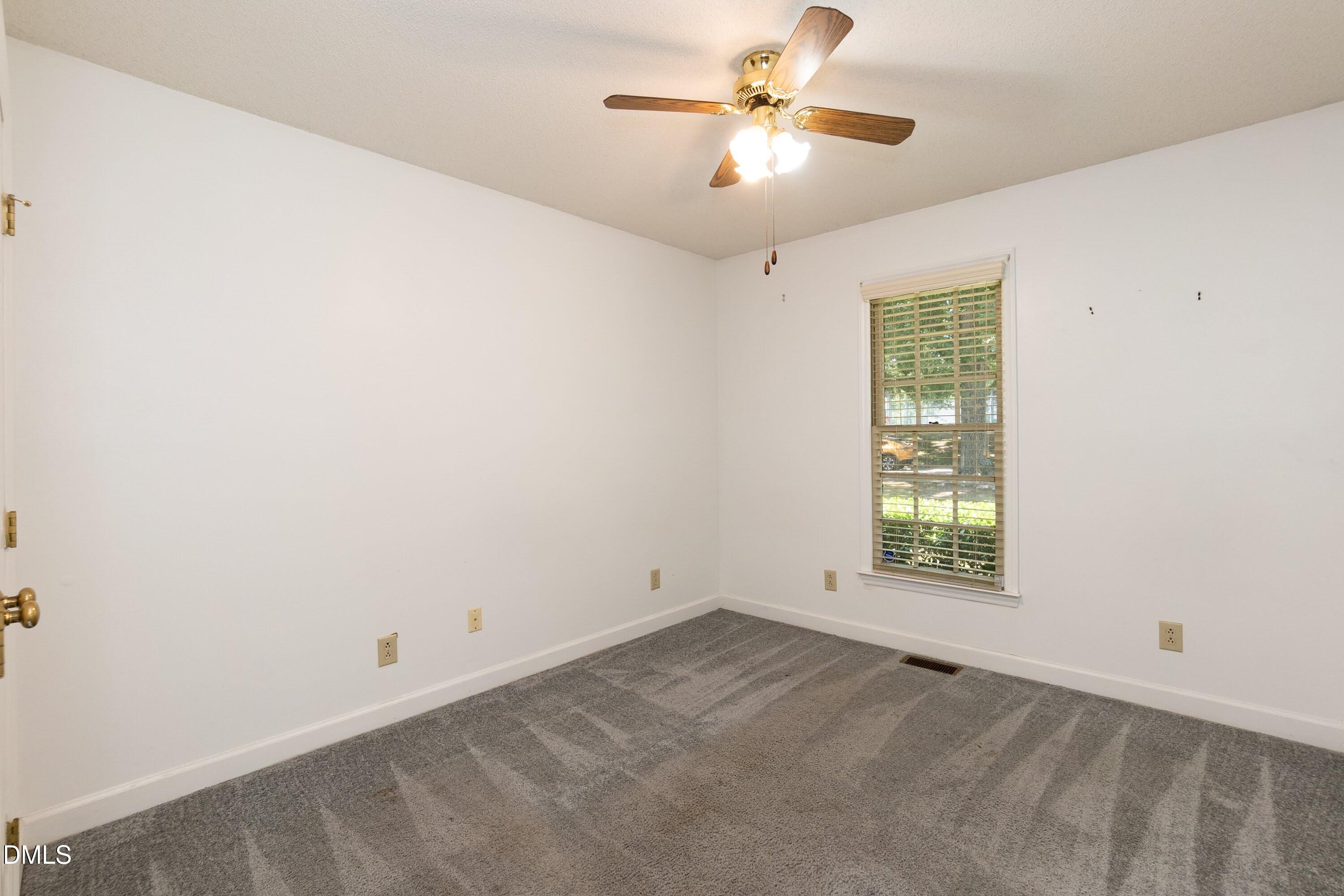 5604 Spring Pines Way Raleigh, NC 27616 - Photo 15 of 22 an empty room with a window and a fan