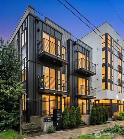 a living room with furniture and floor to ceiling windows