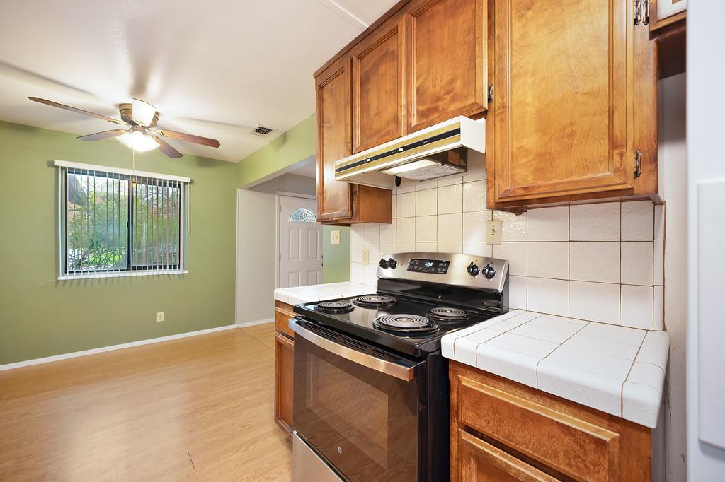 4606 Solano Way Fair Oaks, CA 95628 - Photo 11 of 40 a kitchen with a stove and a microwave