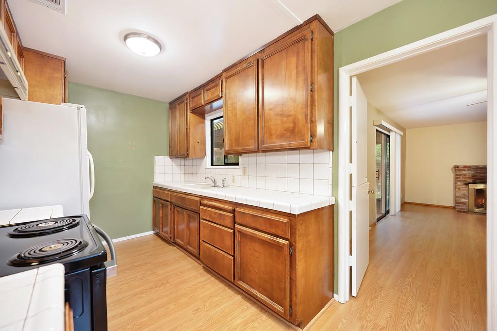 4606 Solano Way Fair Oaks, CA 95628 - Photo 9 of 40 a kitchen with stainless steel appliances granite countertop a sink stove and refrigerator