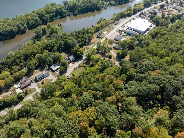 an aerial view of a houses with a lake view