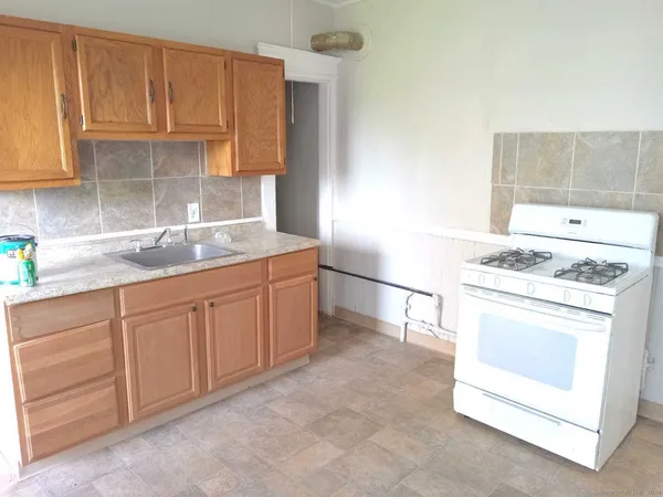 a kitchen with appliances cabinets and a counter top space