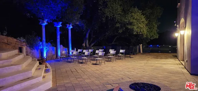 a view of a patio with swimming pool table and chairs