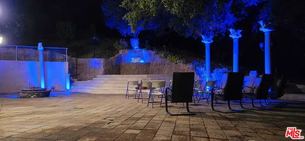 a view of a patio with a table and chairs and potted plants