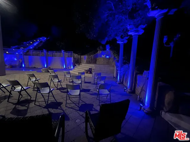 a room with lots of wooden chairs