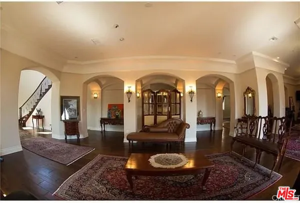 a living room with lots of furniture and a rug