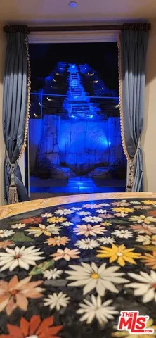 a view of a room with wooden floor and a fireplace