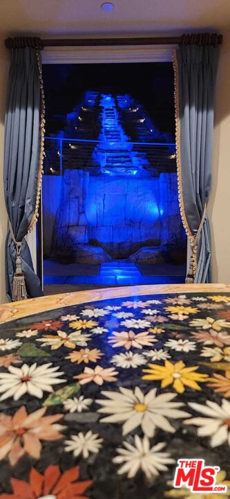 3889 Old Topanga Canyon Road Calabasas, CA 91302 - Photo 10 of 23 a view of a room with wooden floor and a fireplace