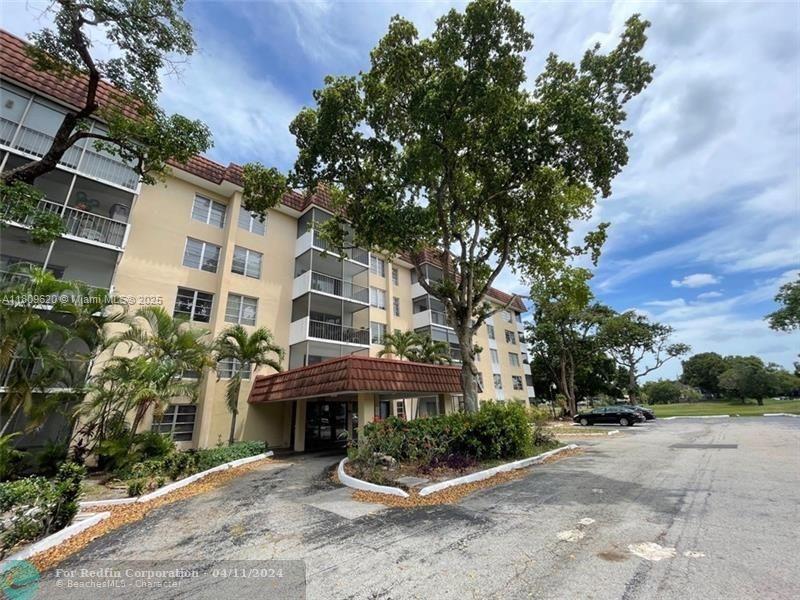 4156 Inverrary Drive, Unit 204 Lauderhill, FL 33319 - Photo 1 of 10 a front view of a house with garden