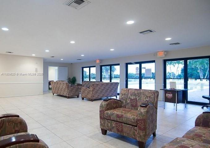 4156 Inverrary Drive, Unit 204 Lauderhill, FL 33319 - Photo 2 of 10 a living room with furniture and a large window