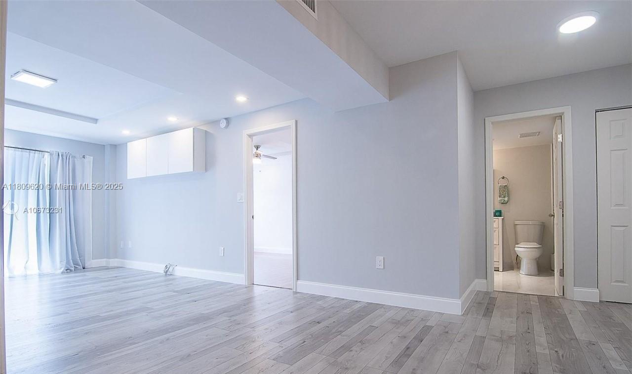 4156 Inverrary Drive, Unit 204 Lauderhill, FL 33319 - Photo 3 of 10 a view of empty room with wooden floor