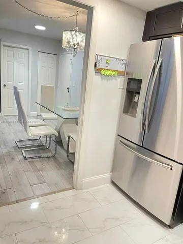a refrigerator freezer sitting inside of a kitchen
