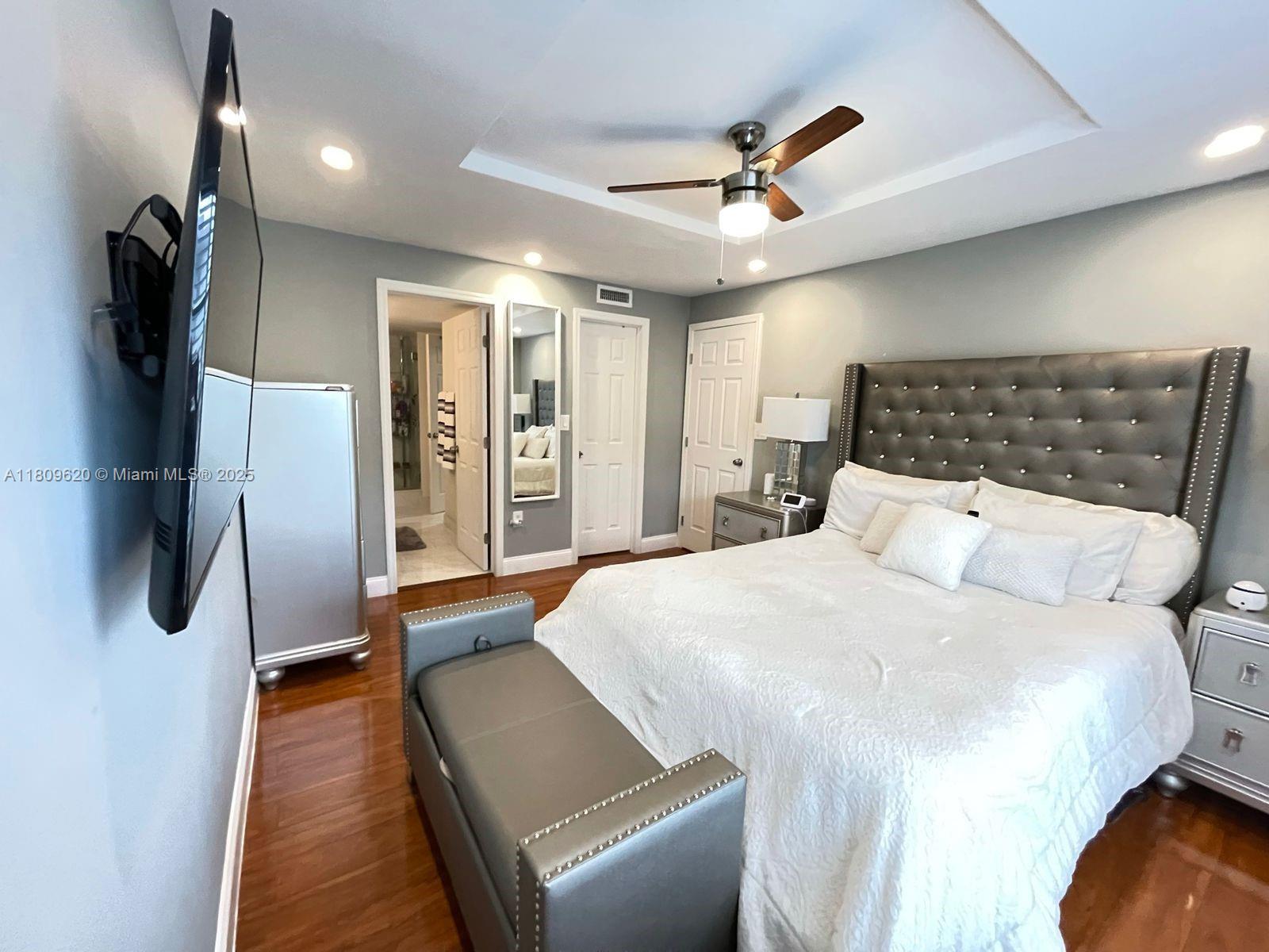 4156 Inverrary Drive, Unit 204 Lauderhill, FL 33319 - Photo 8 of 10 a bedroom with a bed and a walk in closet