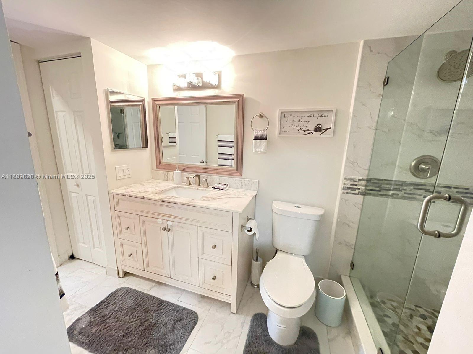 4156 Inverrary Drive, Unit 204 Lauderhill, FL 33319 - Photo 9 of 10 a bathroom with a toilet sink and a mirror