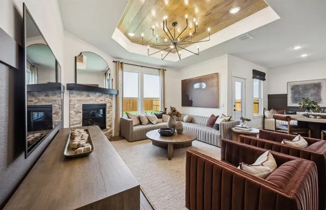 a living room with furniture fireplace and a large mirror