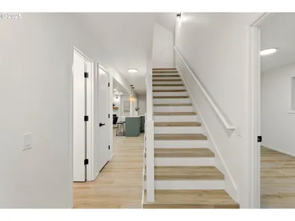 a view of a hallway with wooden floor and entryway