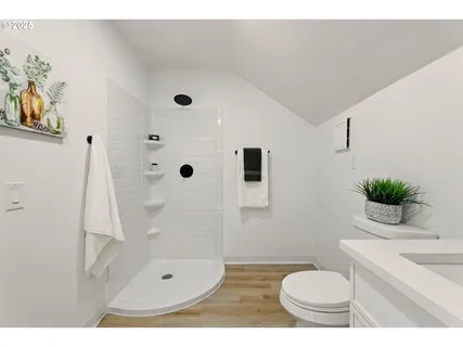 a bathroom with a sink toilet and shower
