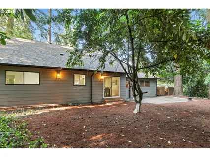 a backyard of a house with barbeque oven