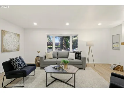 a living room with furniture and a night stand